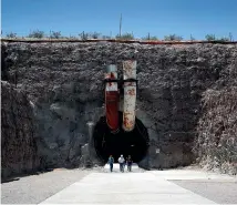  ?? AP ?? People leave the south portal of Yucca Mountain during a congressio­nal tour near Mercury, Nevada, in 2018.