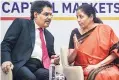  ?? PHOTO:PTI ?? Finance Minister Nirmala Sitharaman ( right) with Sebi Chairman Ajay Tyagi at the NSE in Mumbai