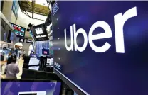  ??  ?? The logo for Uber is seen Aug. 9, 2019, above a trading post on the floor of the New York Stock Exchange.