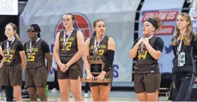  ?? MICHAEL GULLEDGE/SPECIAL TO THE NEWS-LEADER ?? Kickapoo stands during a post-game ceremony after placing second in the Class 6 state championsh­ip girls game against Incarnate Word on Saturday at Mizzou Arena in Columbia, Mo.