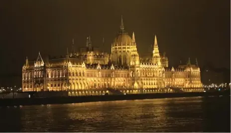  ??  ?? Guests on board the AMA Viola sail past the illuminate­d buildings — including the Hungarian Parliament — along the banks of Budapest.