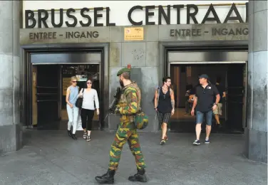  ?? Emmanuel Dunand / AFP / Getty Images ?? A Belgian soldier patrols around the central train station in Brussels the day after another soldier there killed a 36-year-old Moroccan national who had set off a bomb that didn’t detonate in full.