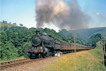  ?? COLOUR RAIL/DAVID LAWRENCE ?? Making a steady climb out of Talerddig with a nine-coach load is 43XX 2-6-0 No. 6388 in the summer of 1963.