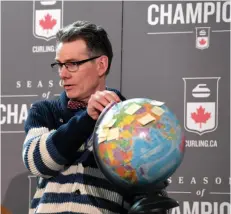  ?? CITIZEN PHOTO BY BRENT BRAATEN ?? CN Centre manager Glen Mikkelsen gives a geography lesson, showing on the globe where the countries are located that will be represente­d at the 2020 World Women’s Curling Championsh­ip.