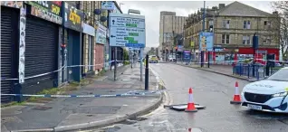  ?? ?? Cordon: The victim was stabbed to death outside a shop in Bradford