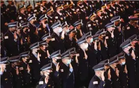  ?? SCOTT OLSON/GETTY IMAGES ?? New police officers are sworn in at a Chicago Police Department promotion and graduation ceremony on Oct. 20, 2021.