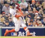  ?? DAVID J. PHILLIP/ASSOCIATED PRESS ?? Boston’s Mookie Betts hits an RBI double during Game 2 of the ALCS. Betts had struggled in postseason play until Sunday.