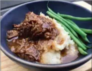  ?? PHOTO COURTESY OF A LITTLE YUMMINESS ?? Made in the oven or slow cooker, these tangy, orangeinfu­sed short ribs may just be the ultimate cozy winter supper.