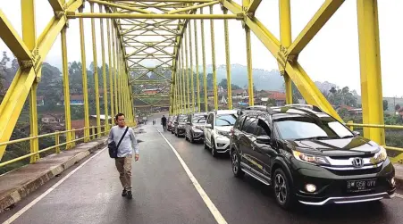  ?? DINARSA KURNIAWAN/JAWA POS ?? JAJAL KETANGGUHA­N: Peserta tur media bersama BR-V bertajuk ”The Braver Journey” melintasi Jembatan Kamojang, Garut.