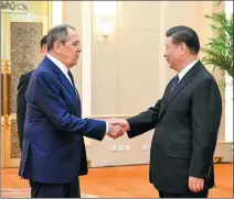  ?? LI XUEREN / XINHUA ?? President Xi Jinping shakes hands with Russian Foreign Minister Sergey Lavrov in Beijing on Tuesday.