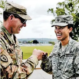  ?? RICHARD DREW/AP ?? Cadet Capt. Simone Askew shares a fun greeting Monday at West Point with Brigade Tactical Officer Col. Brian Reed.