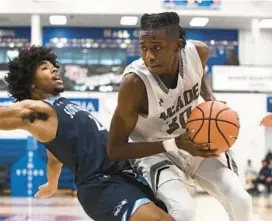  ?? PAUL W. GILLESPIE/BALTIMORE SUN MEDIA ?? Meade’s Shawn Jones gets charged with an offensive foul on South River’s Trashaun Timmons in the fourth quarter Saturday during the Capital Hoops Challenge at DeMatha Catholic.