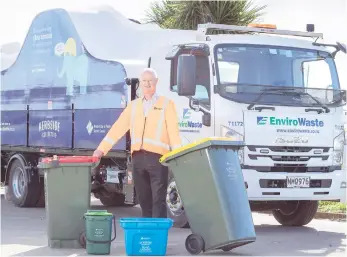  ??  ?? Council’s Deputy CEO and Group Manager Infrastruc­ture Services, Gary Allis with the new Kerbside Collective bins and trucks. PHOTO: Supplied.