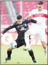  ??  ?? Stuttgart’s Konstantin­os Mavropanos (right), and Bremen’s Milot Rashica challenge for the ball during the German Bundesliga soccer match between VfB