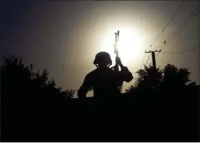  ??  ?? Afghan policeman stands guard at the site of a suicide bomb attack near a Shiite mosque in Kabul on September 29.