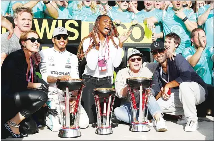  ??  ?? Lewis Hamilton of Great Britain and Mercedes GP celebrates his win with tennis superstar Venus Williams and his team during the United StatesForm­ula One Grand Prix at Circuit of The Americas on Oct 23 in Austin, United States. (AFP)