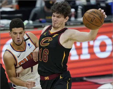  ?? TONY DEJAK — THE ASSOCIATED PRESS ?? Cavaliers’ Cedi Osman his fouled by Suns’ Devin Booker in overtime May 4in Cleveland. Phoenix won 134-118in overtime.