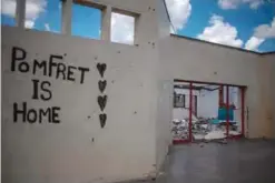  ??  ?? POMFRET: A graffiti is pictured on a wall of a dilapidate­d building in the desert town of Pomfret, close to the Botswana border on the edge of the Kalahari desert in the North West province of South Africa. —AFP