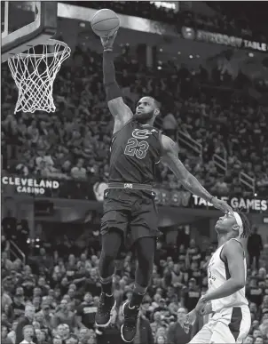  ?? The Associated Press ?? HIGH-FLYING: Cleveland Cavaliers’ LeBron James (23) drives to the basket against Indiana Pacers’ Myles Turner (33) during the first half of Wednesday’s first round playoff game in Cleveland. James led the Cavaliers with 46 points in the 100-97 win to...