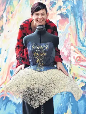  ?? PHOTO: PETER MCINTOSH ?? Off the page . . . Dunedin Public Library assistant and fashion design graduate Jill Bowie displays the dress she created from the pages of a damaged pages and and buckram offcuts.