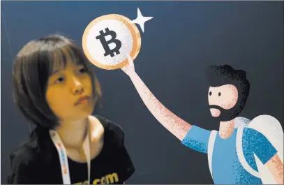  ?? Marcus Villagran ?? Las Vegas Review-journal @brokejourn­alist Irina Liu, marketing manager of Btc.com, works at her company’s booth at the Blockshow convention Tuesday at The Venetian.