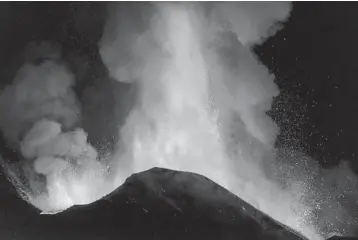  ?? SALVATORE ALLEGRA/AP ?? Spectacula­r spurts of lava: Lava spews skyward from Mount Etna, near Catania in Sicily, during an eruption late Monday. The eruption petered out Tuesday morning, according to Italy’s National Institute for Geophysics and Volcanolog­y. Etna has been belching lava, ash and volcanic rocks on a regular basis for more than a week.