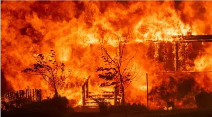  ?? AP PHOTO/NOAH BERgER ?? Flames consume a home as the River Fire tears though Lakeport, Calif., on Tuesday.