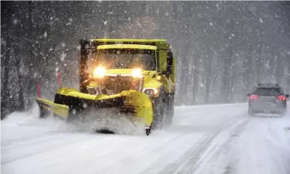  ??  ?? A snow plow clears the road surface on Route 7, on Sunday in New Ashford, Massachuse­tts. Photograph: Gillian Jones/AP