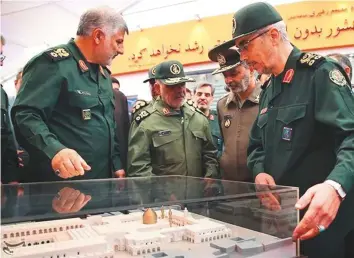  ??  ?? Iranian generals at an exhibition held at Khatam Al Anbiya’s headquarte­rs in Tehran. The company is the recipient of billions of dollars worth of government contracts, often without a tender system.