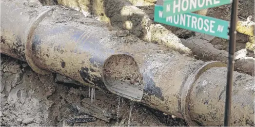  ?? AP ?? A broken water main in Chicago. When service lines to individual buildings develop leaks, it can mean a huge bill for property owners, through no fault of their own.