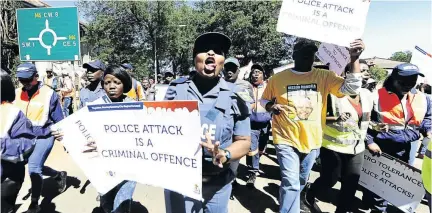  ?? / THULANI MBELE ?? Police and Community Policing Forum members are joined by members of the public in a march against violence towards police officers in Vanderbijl­park.