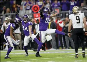  ?? CHARLIE NEIBERGALL — THE ASSOCIATED PRESS ?? Vikings strong safety Andrew Sendejo (34) celebrates his intercepti­on with cornerback Trae Waynes (26) and outside linebacker Anthony Barr (55) as Saints quarterbac­k Drew Brees (9) looks on.