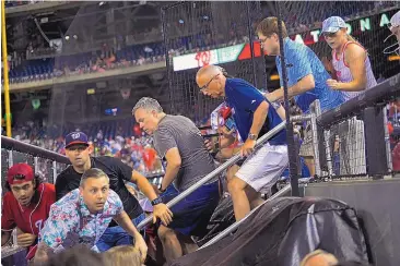  ?? JOHN MCDONNELL/WASHINGTON POST VIA AP ?? Fans rush to evacuate Nationals Park after hearing gunfire outside the stadium during Washington’s game against visiting San Diego.