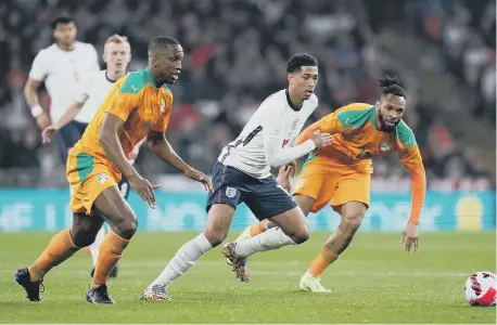  ?? ?? England’s Jude Bellingham in action with Ivory Coast’s Willy Boly and Maxwel Cornet.