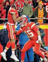  ?? [AP PHOTO] ?? Kansas City Chiefs quarterbac­k Patrick Mahomes (15) celebrates with wide receiver Demarcus Robinson (11) after Robinson caught a touchdown pass during the first half of Thursday night’s game against the Los Angeles Chargers in Kansas City.