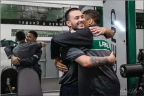  ?? SHARON HOLY - SHARON HOLY PHOTOGRAPH­Y ?? Dorian Gridiron, right, hugs his brother Adrian Salas. Salas pulled Gridiron in a kayak for half a mile after both young men fell off a cliff in a 2016 hiking accident. Gridiron is back wrestling for the first time after that near-fatal fall.