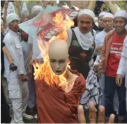  ?? — AFP ?? Protesters ( left) shout slogans against Rohingya boat migrants during a demonstrat­ion in Yangon, Myanmar, on Wednesday. Indonesian hardline Muslim group Front Pembela Islam, or Islamic Defender Front, and Forum Umat Islam activists burn an effigy of a...