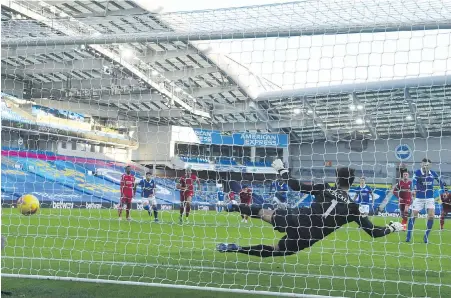  ?? POOL VIA AP ?? Brighton’s Pascal Gross, in blue right, scores the equalizer against Liverpool at the Amex Stadium on Saturday.