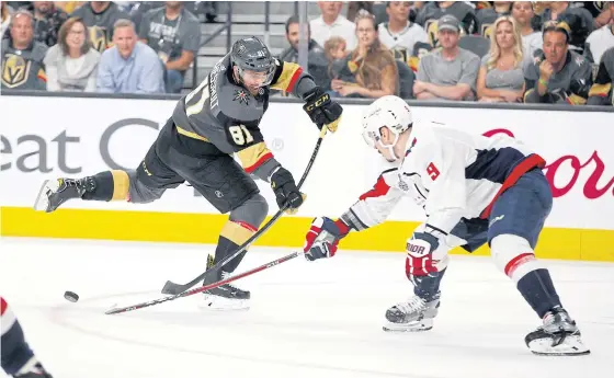  ??  ?? The Golden Knights’ Jonathan Marchessau­lt, left, tries to shoot the puck past the Capitals’ Dmitry Orlov during Game One of the Stanley Cup Final in Las Vegas.