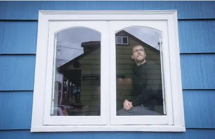  ?? — THE CANADIAN PRESS ?? David Repa is photograph­ed through a window at his home in Powell River. Repa recalls the shock he felt realizing how slim his prospects were of home ownership in Vancouver.