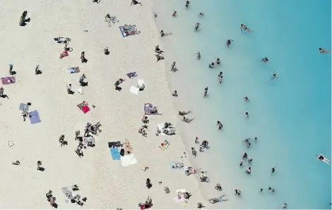  ?? LOUISA GOULIAMAKI/AFP/GETTY IMAGES FILES ?? Tourists enjoy the beach on the Greek island of Zakynthos, also known as the ‘Island of the Blind’ because of a scheme undertaken by hundreds of inhabitant­s who falsely claimed they were blind to receive monthly compensati­on.