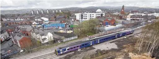  ??  ?? ●●A train passes through Rochdale railway station