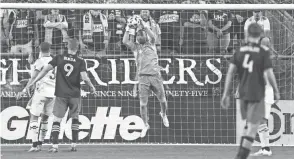  ?? PAUL RUTHERFORD/USA TODAY SPORTS ?? Crew goalkeeper Eloy Room stayed in the game after injuring a leg and made three saves from the 90th minute into stoppage time against New England on Saturday.