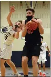  ?? OWEN MCCUE - MEDIANEWS GROUP ?? Boyertown’s Chris Kiefer, left, hauls down a rebound as Pope John Paul II’s JP Baron reaches out for the ball.