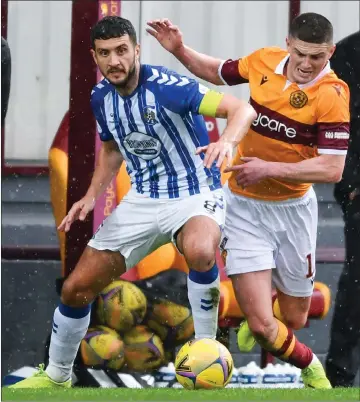  ??  ?? Killie’s Gary Dicker, left, and Jake Hastie battle for the ball during Motherwell’s 2-0 victory