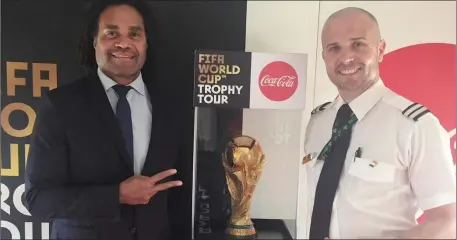  ??  ?? Christian Karembeu, retired French internatio­nal footballer, and 1998 World Cup winner, with Brian McGovern and the World Cup.