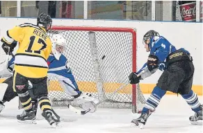  ??  ?? Grant Reekie nets for Tigers despite close attention from Storm players.