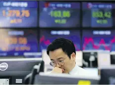  ?? AHN YOUNG- JOON/ THE ASSOCIATED PRESS ?? A currency trader works at the KEB Hana Bank in Seoul on Thursday. Risk is a personal thing that means building the right portfolio to fit your needs, says Tom Bradley.