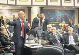  ?? SCOTT KEELER/AP ?? State Rep. Joseph Abruzzo, D-Boynton Beach, left, takes part in Wednesday’s emotional debate on the school safety bill on the floor of the House.