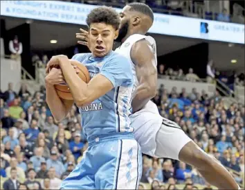  ??  ?? Cameron Johnson pulls down one of his nine rebounds Saturday against his former team.